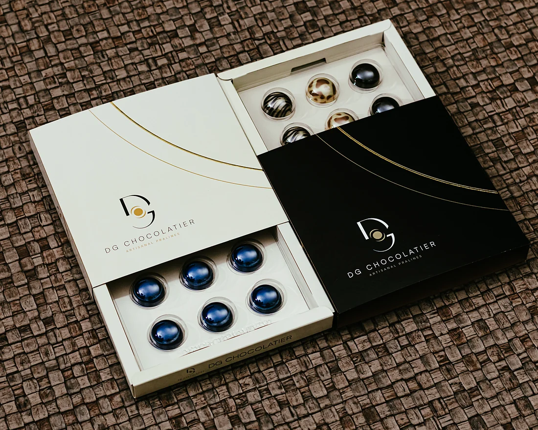 A cream and a black box, both open